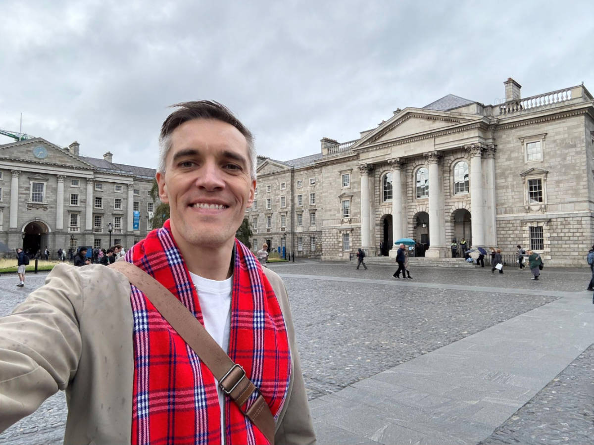 Nate Hake smiling for a selfie at the Trinity College