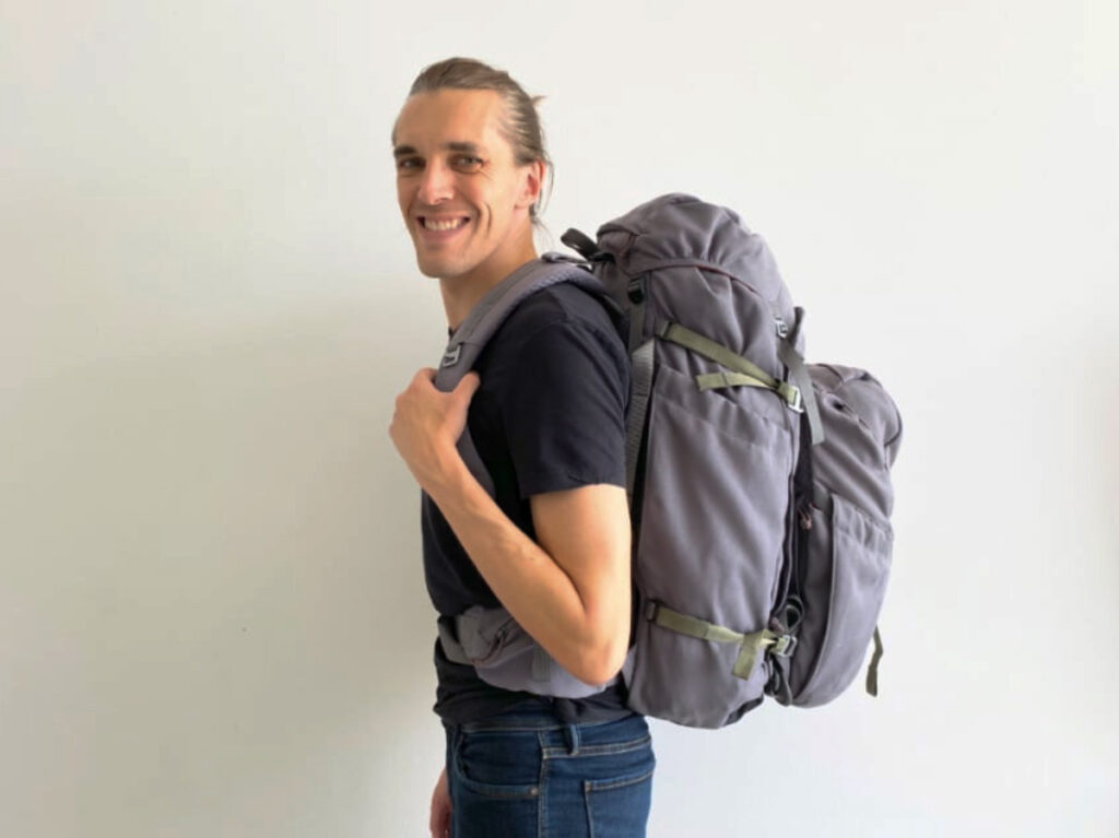 Nate Hake smiling for a photo while wearing the Salkan Mainpack and Daypack