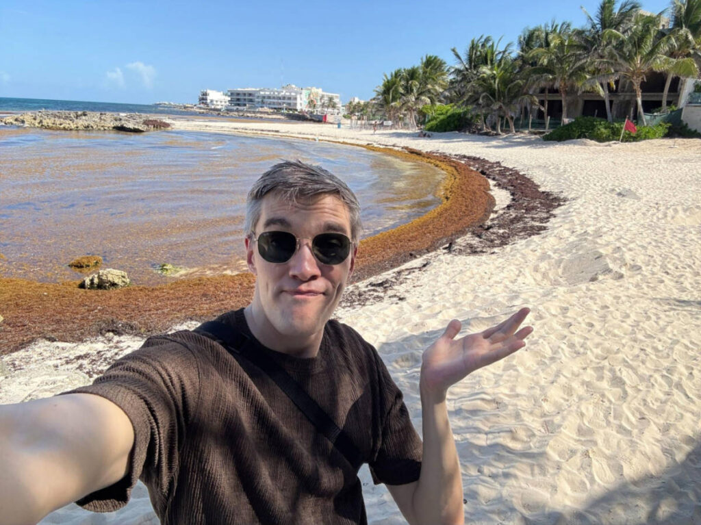 Travel Lemming founder Nate Hake showing Cancun’s Sargassum at the beach