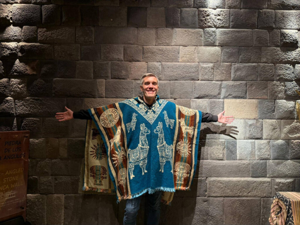 Travel Lemming Founder Nate Hake, posing for a photo while wearing a poncho