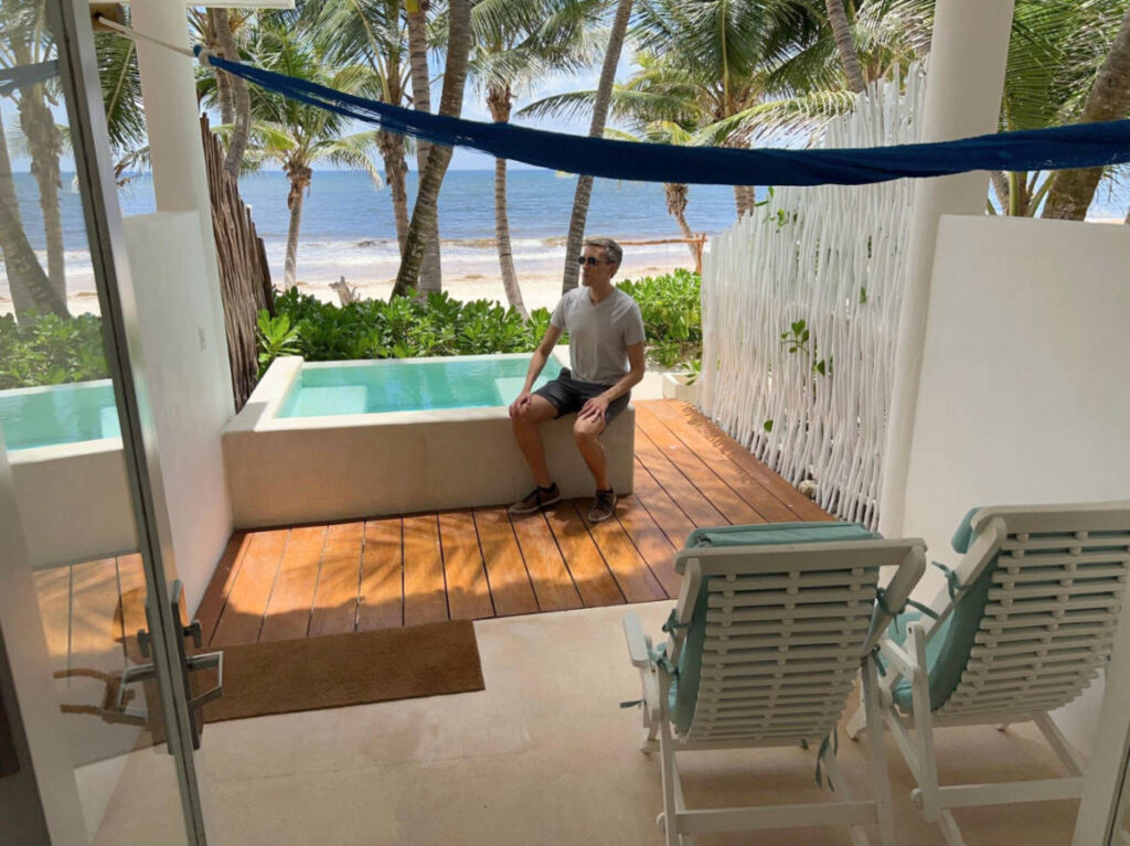 Travel Lemming founder Nate Hake, sitting on the ledge of the private pool at Cabañas Tulum