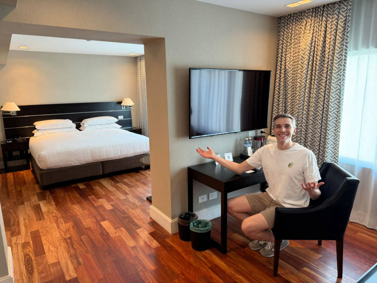 Travel Lemming founder, Nate Hake, sitting in the room's workstation in Buenos Aires Marriott