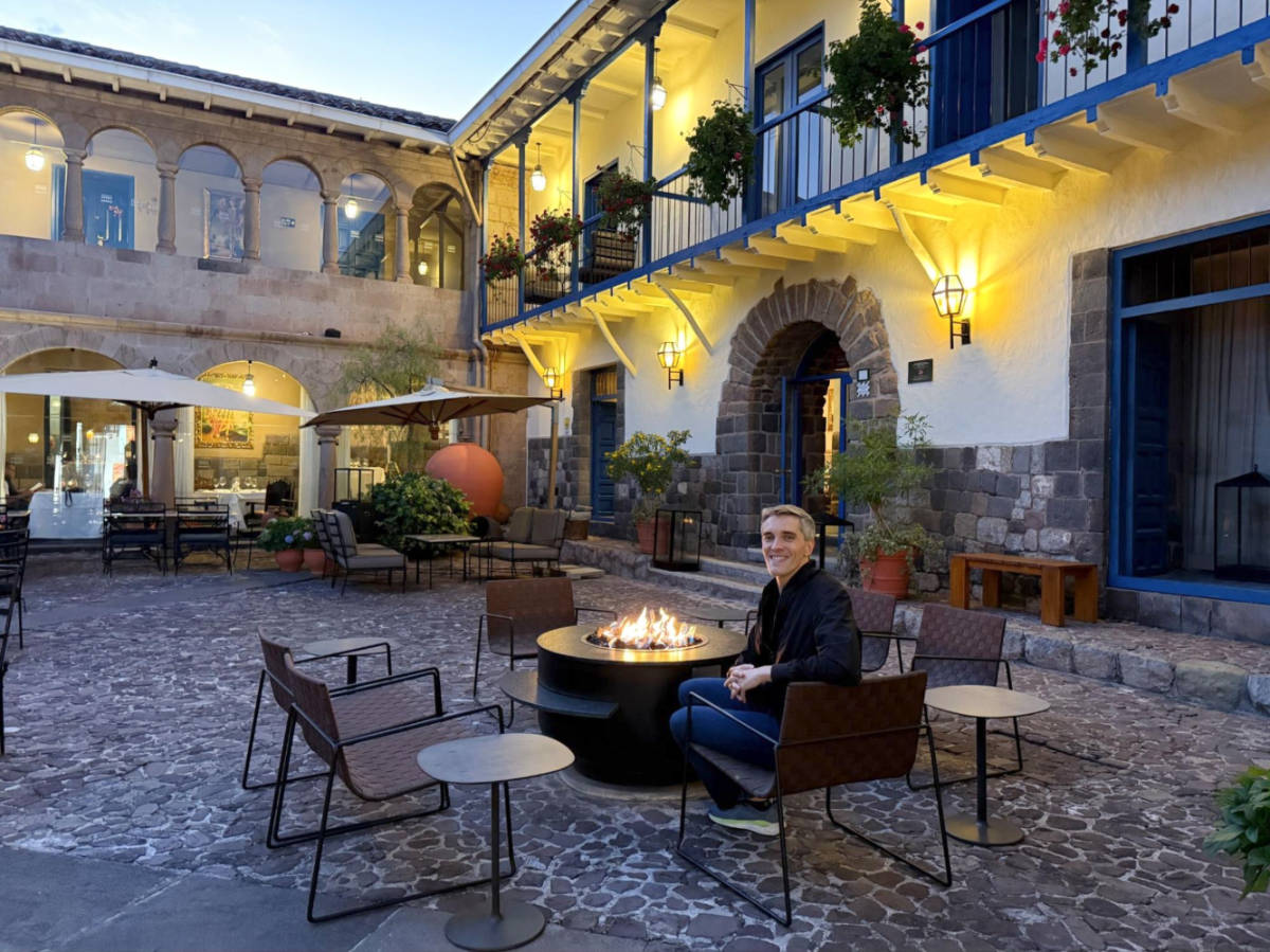 The author Nate Hake, enjoying the fire at the hotel courtyard of Palacio del Inka