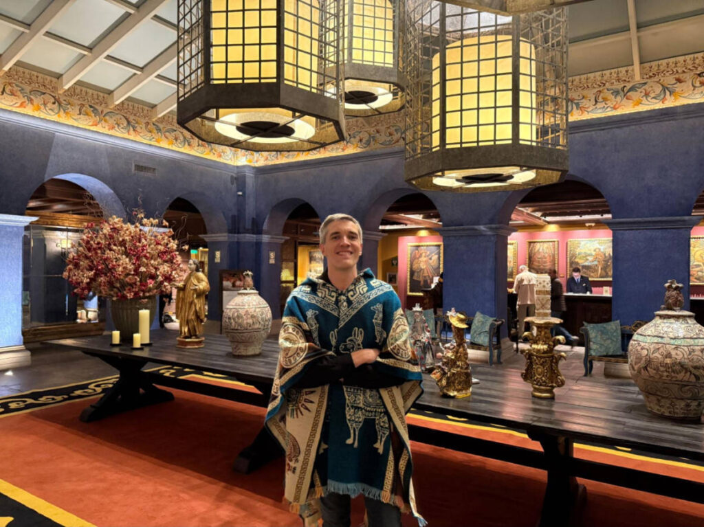 The author Nate Hake, posing for a photo in the middle of the lobby of Palacio del Inka