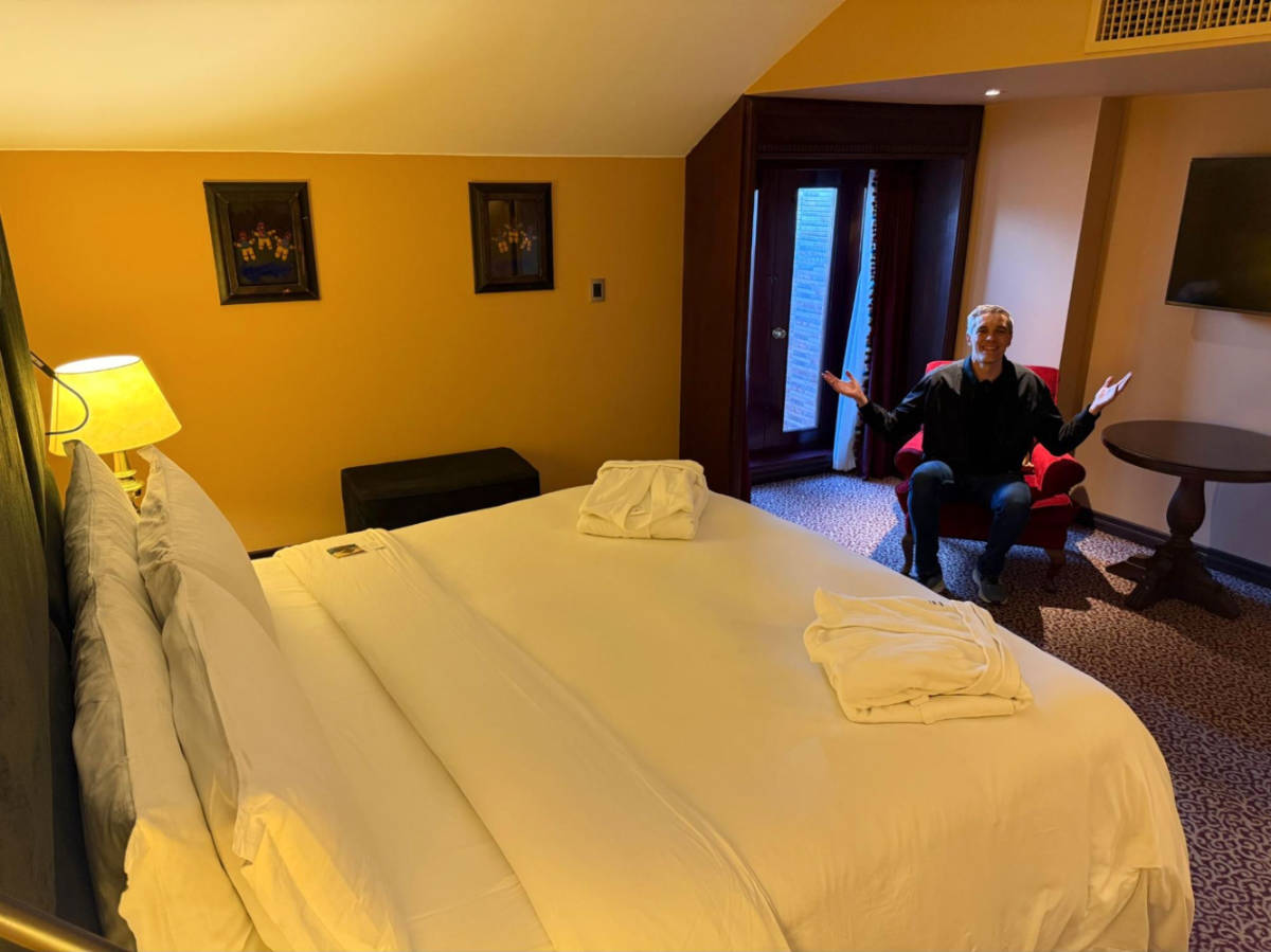 The author Nate Hake, sitting inside the hotel room at the Palacio del Inka