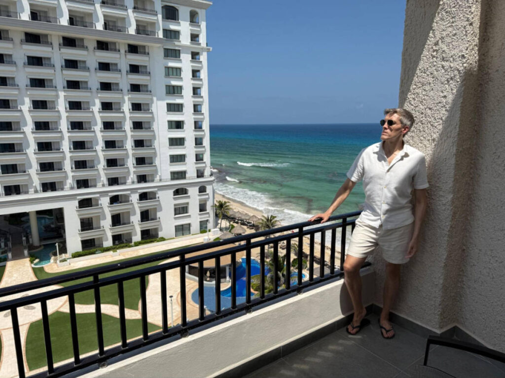 Travel Lemming founder Nate Hake, standing on his balcony at the Marriott Cancun All-Inclusive