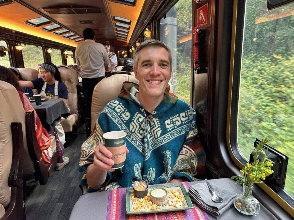 Travel Lemming founder Nate Hake, drinking inside the Inca Rail’s The Prime Train