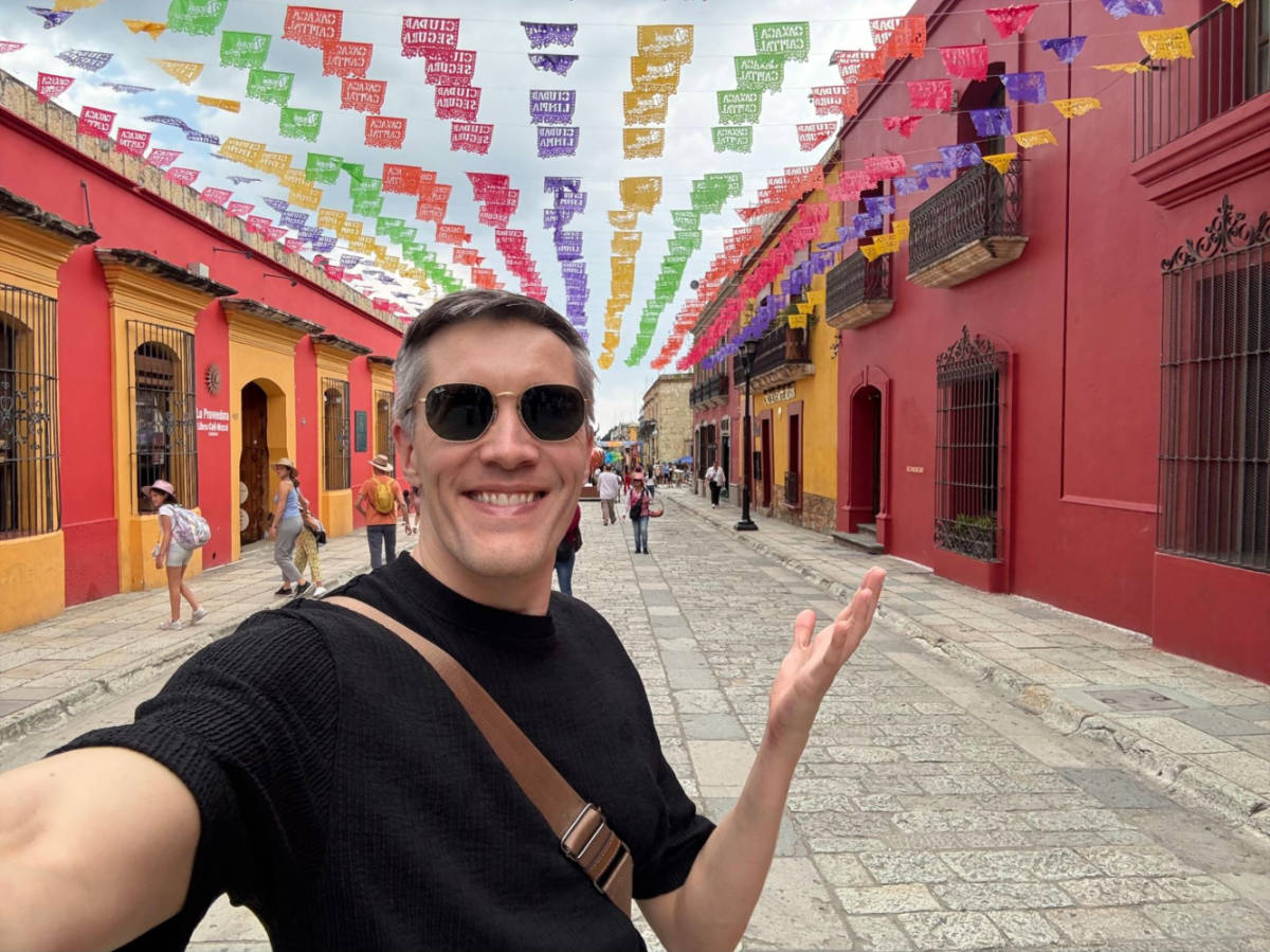 Travel Lemming founder Nate Hake, standing in the middle of the colorful streets of Oaxaca City