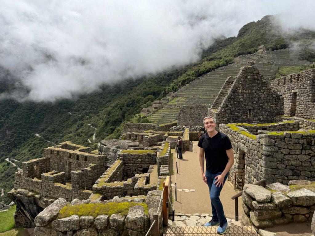 Travel Lemming Founder Nate Hake, standing on the lower ruins at Machu Picchu