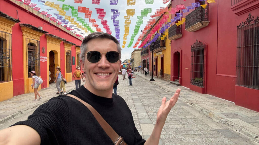 Travel Lemming founder Nate Hake, standing in the middle of the colorful streets of Oaxaca City