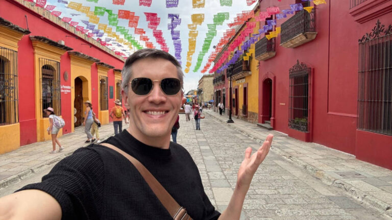 Travel Lemming founder Nate Hake, standing in the middle of the colorful streets of Oaxaca City