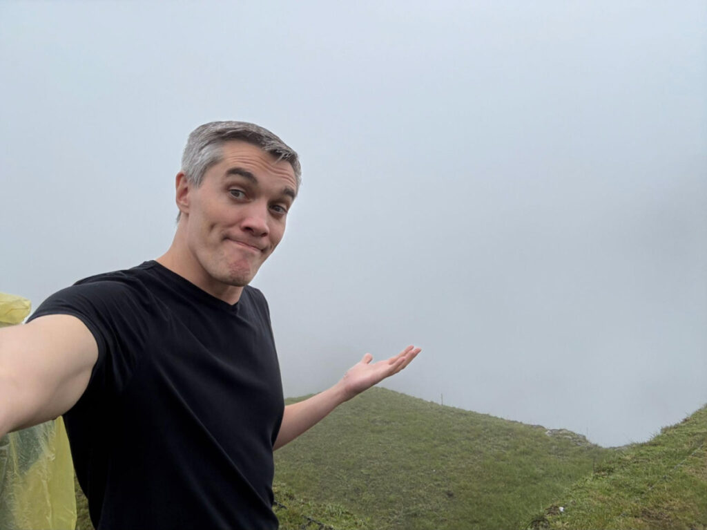 Travel Lemming founder Nate Hake, showing the foggy view of Machu Picchu