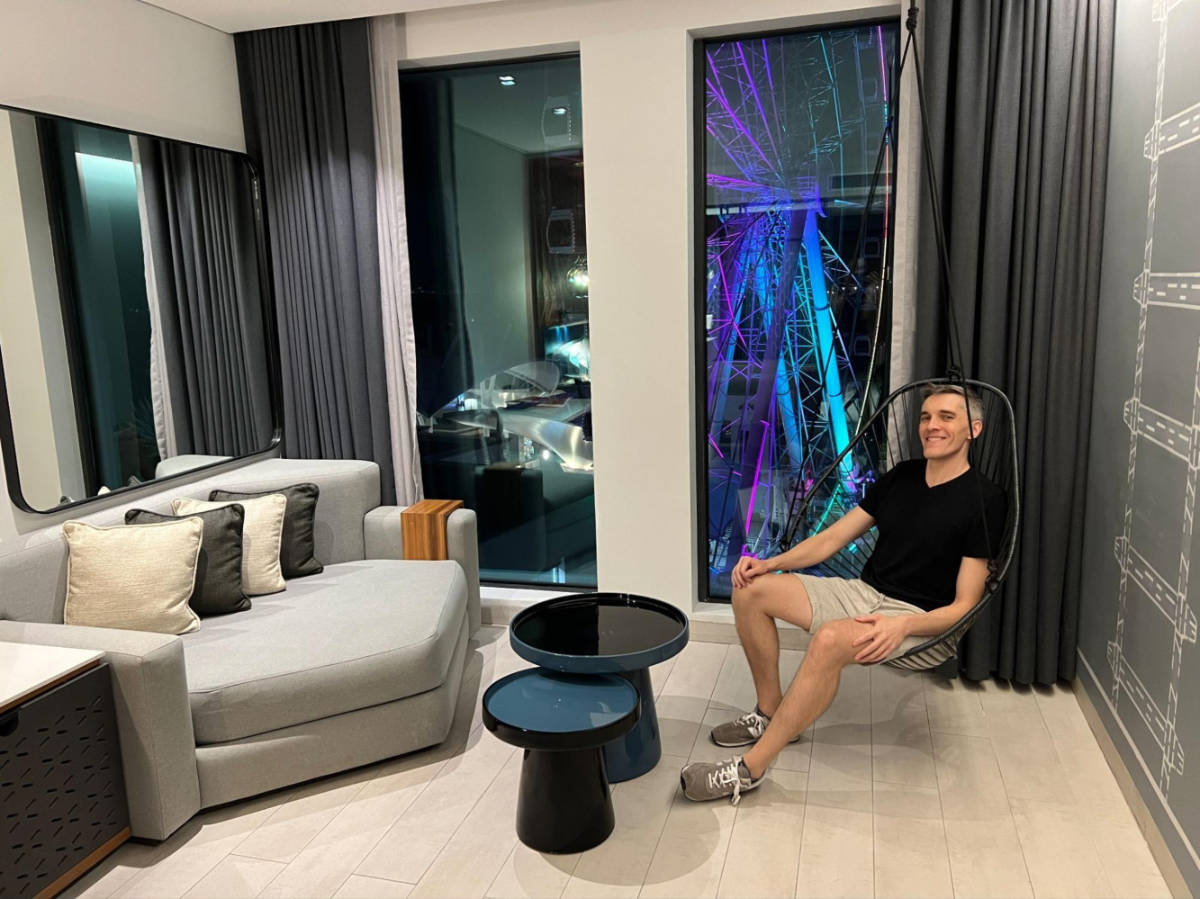 Travel Lemming founder Nate Hake, sitting on a swing inside the room at Canopy By Hilton Cancun La Isla
