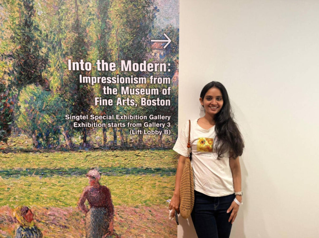 The author, Advaita smiling for a photo in National Gallery Singapore