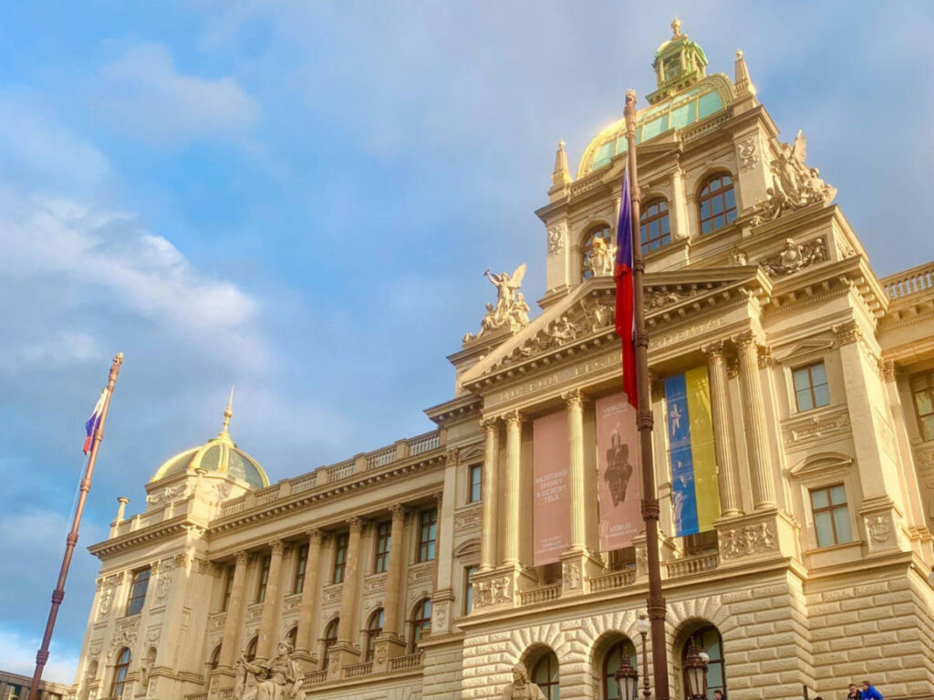 view of the golden and intricate exterior of the National Museum in Prague