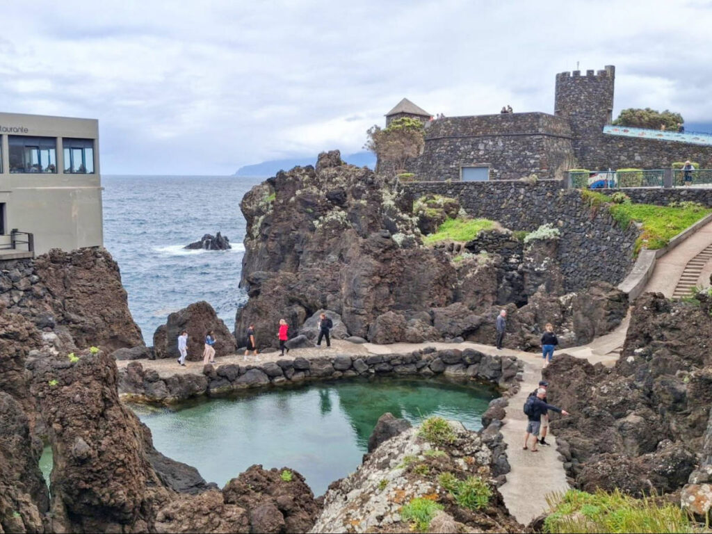 Overlooking view of the people walking around the natural pools of Porto Moniz