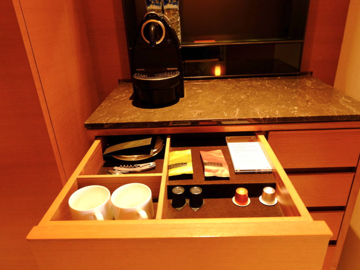A Nespresso machine with complimentary pods and tea