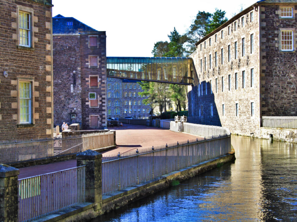 View of the restored mill buildings near the river in New Lanark
