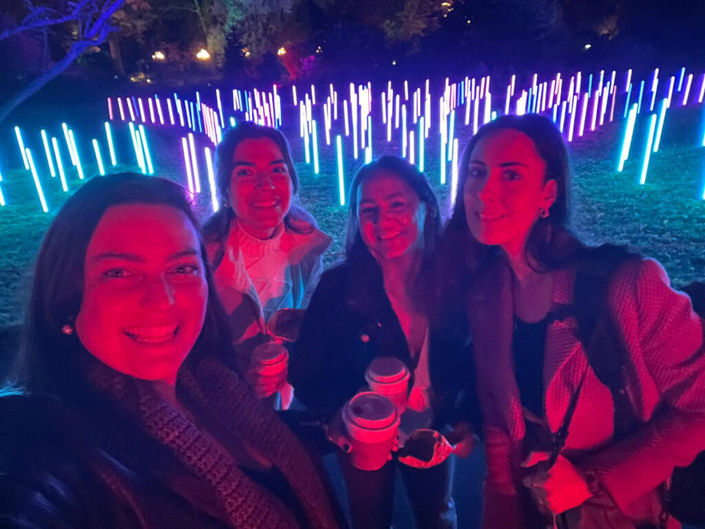 The author Niamh Hayes and her friends, smiling for a photo at The Brooklyn Botanic Gardens Light Show