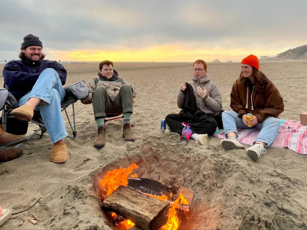The author, Laura McFarland with her friends around a fire pit that they made in Ocean Beach