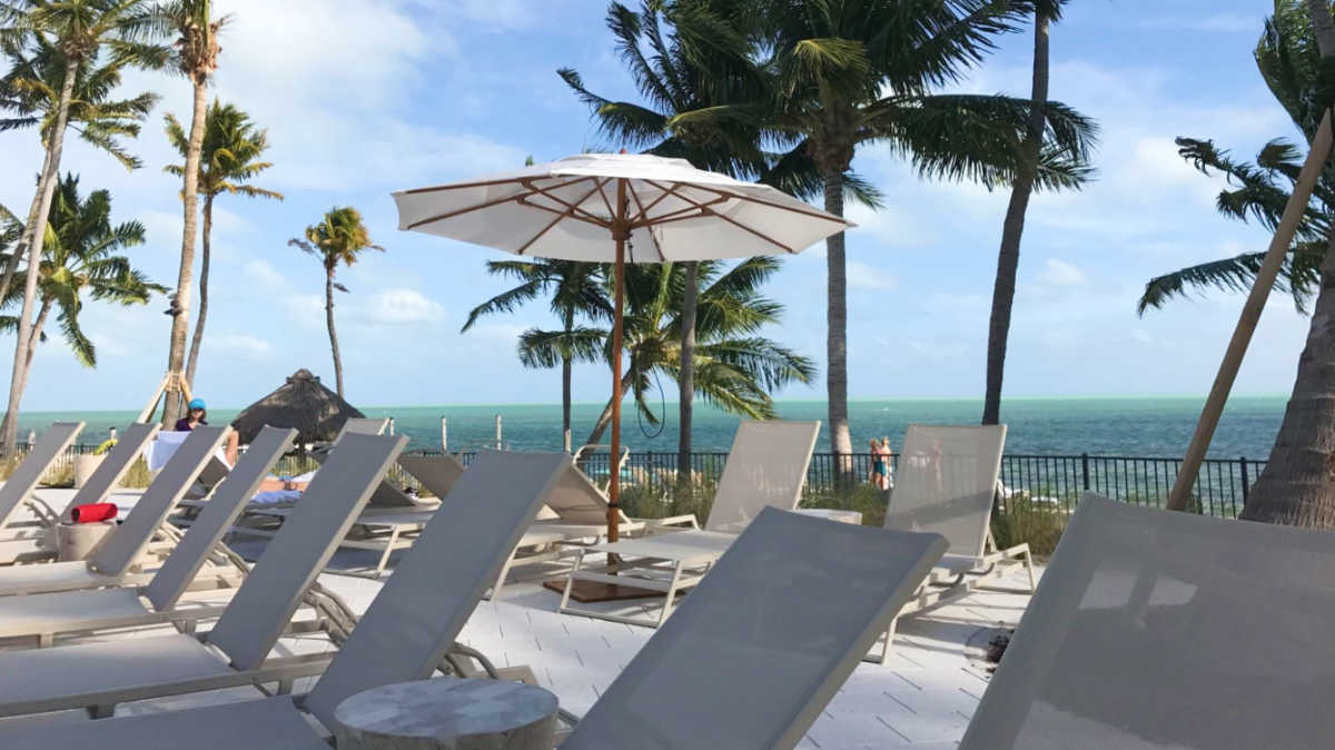 View of the oceanfront lounging area by the pool at Amara Cay