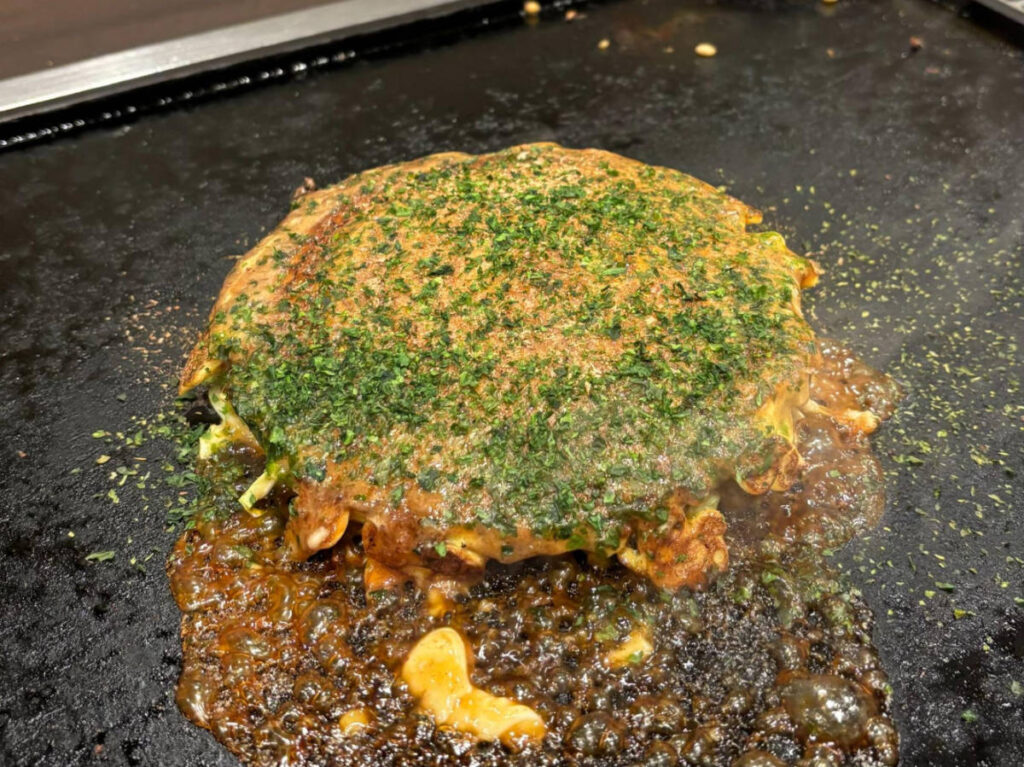 A okonomiyaki being cooked in Asakusa