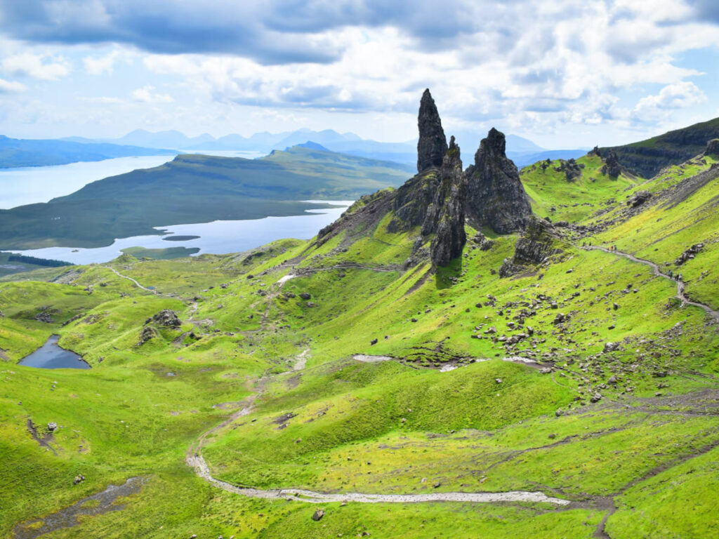 Aerial view of the standing rocks of the Old Man of Storr surrounded by vast greenery