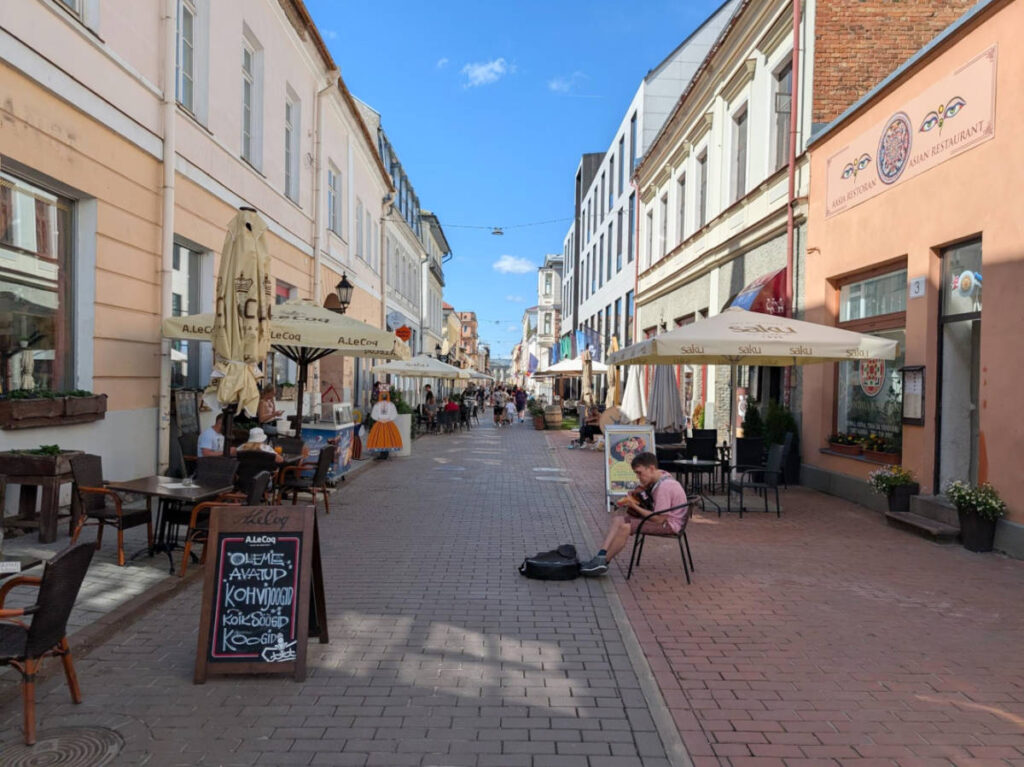 View of the charming street of the Old Town Tartu surrounded by restaurants and shops