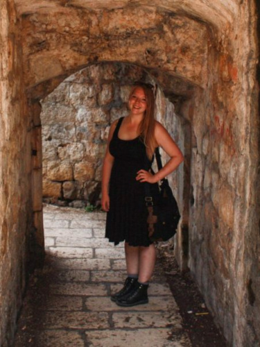Author Taylor standing in an old passageway in Dubrovnik