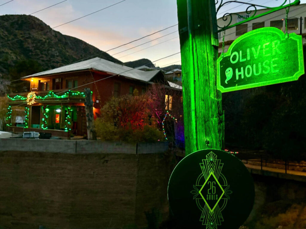 The Oliver House and 26 Souls signage with green light
