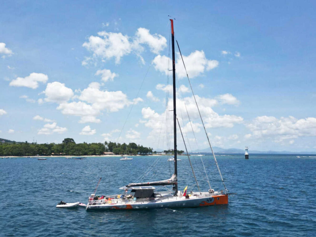 View of the Open 66 race boat in the middle of the ocean