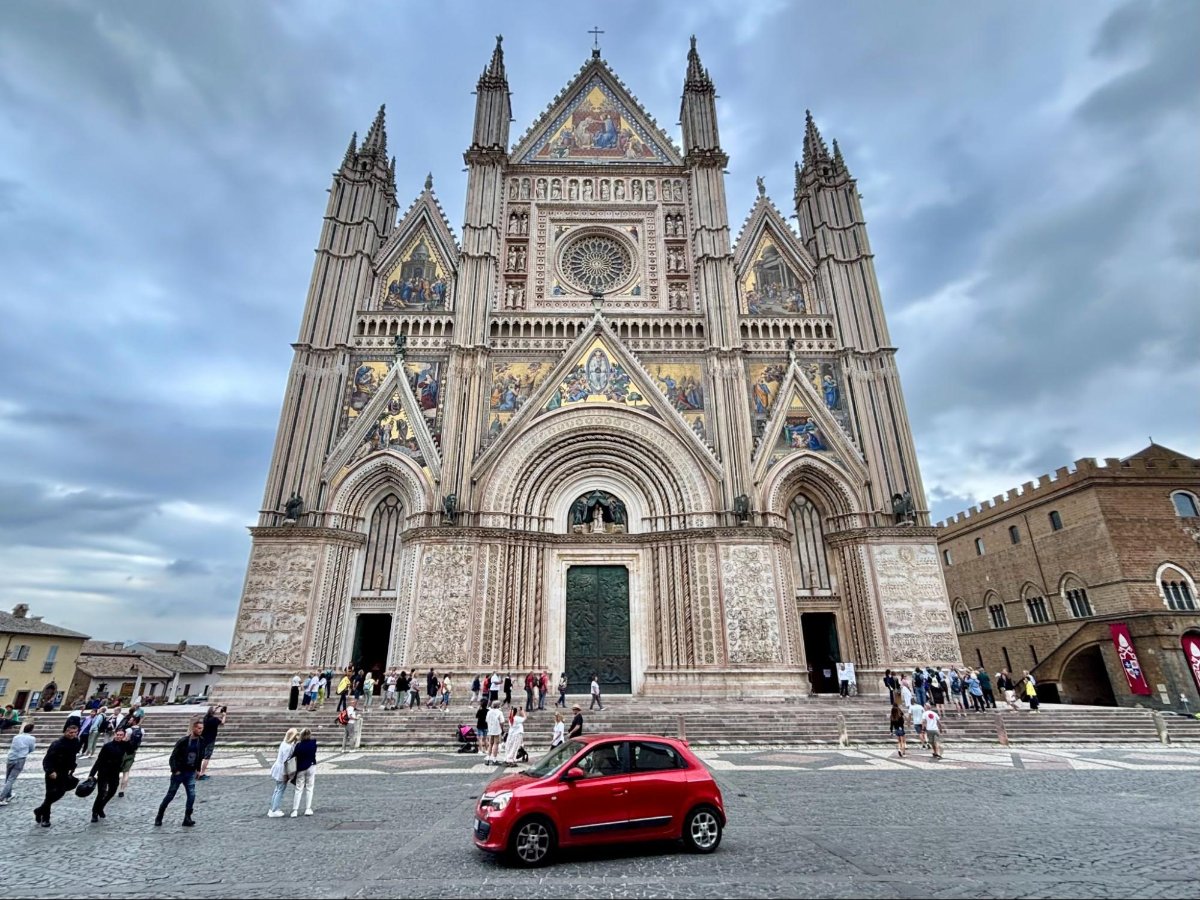 A red car in front of Orvieto Cathedral