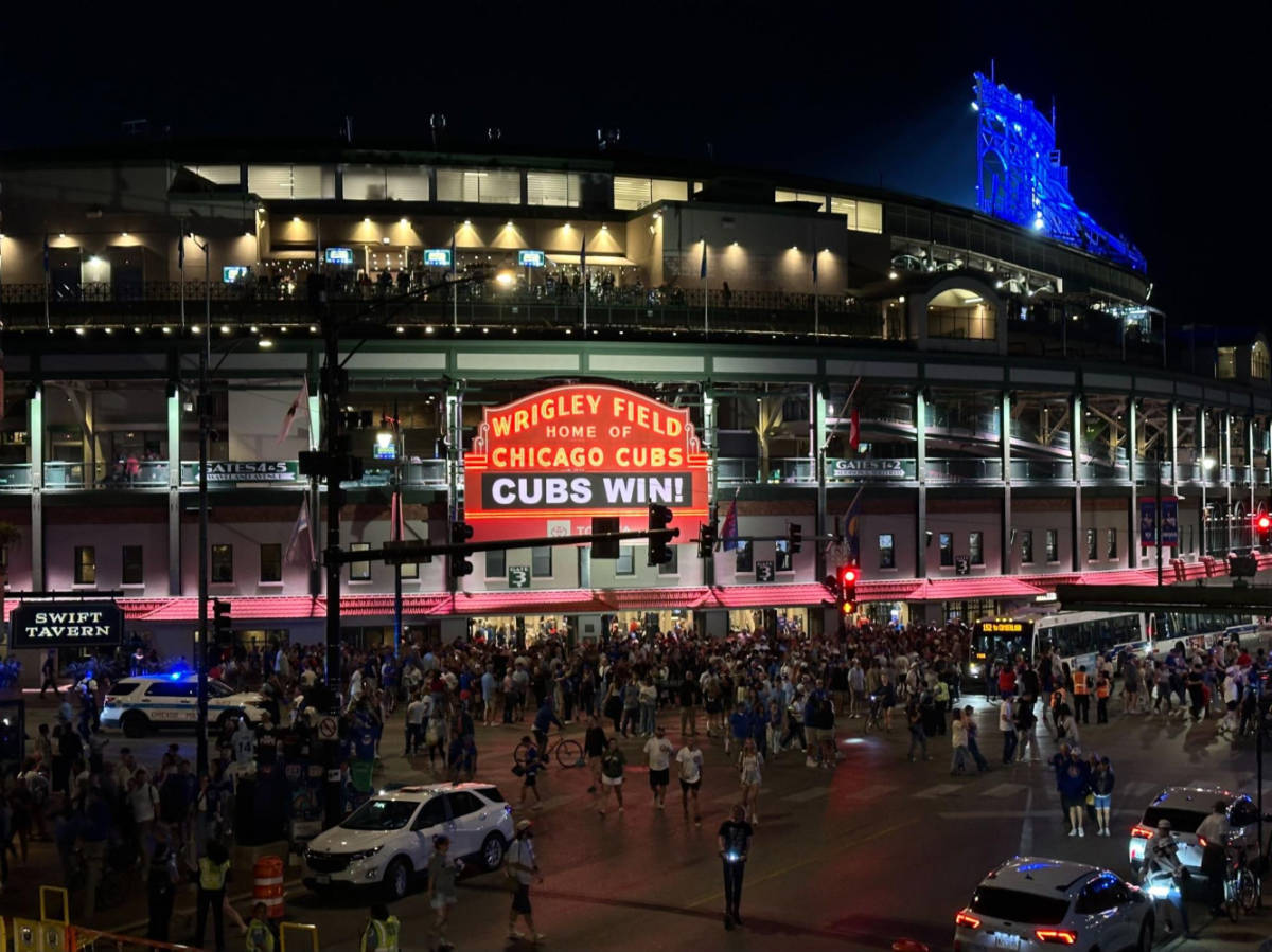People outside the Wrigley Field in Chicago at night