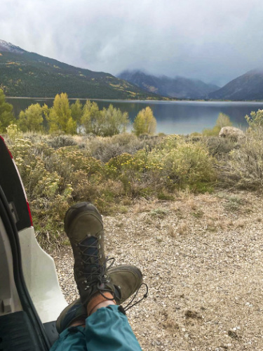 View of the hiking boots on the car overlooking the view