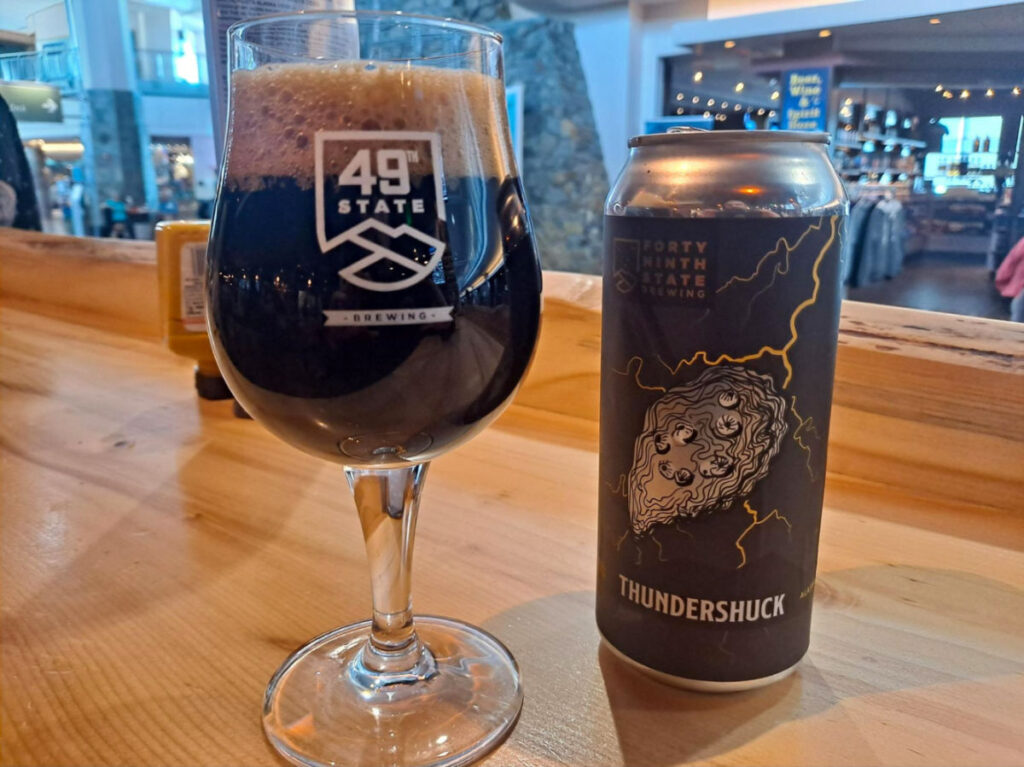 A glass and bottle of Oyster porter of 49th State Brewing