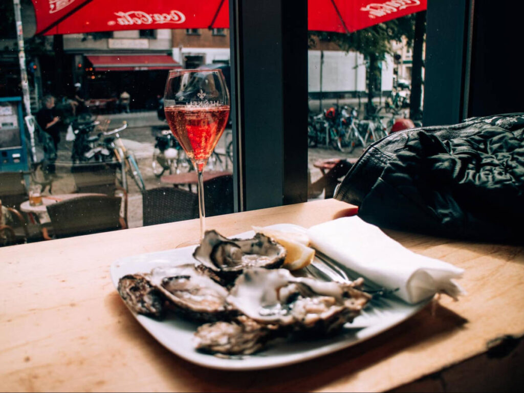 A plate of oysters and a glass of cava by the window at Marheineke Markthalle