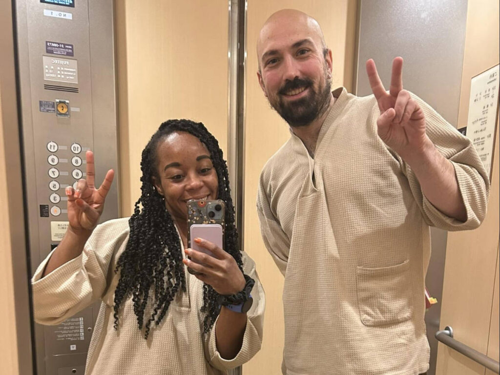 The author Chelsea Booker with her husband wearing the hotel's pajamas at Onyado Nono Asakusa Natural Hot Spring