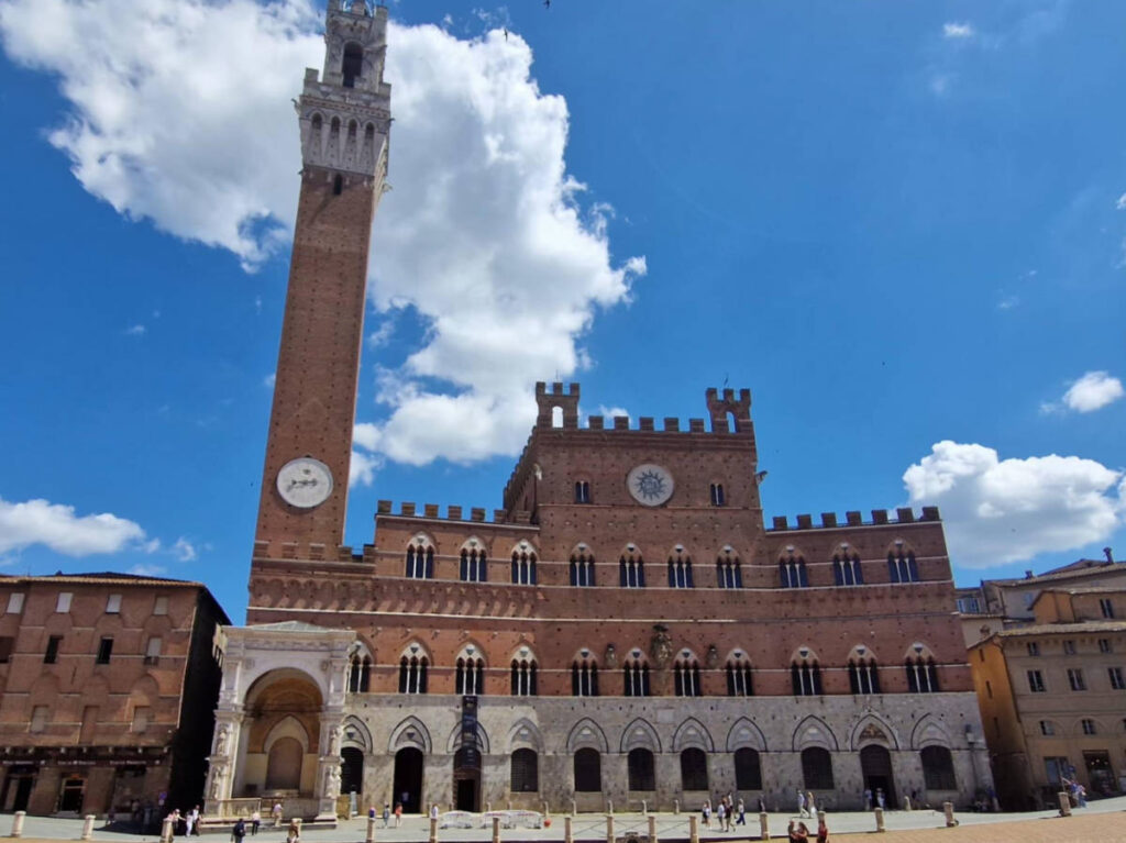Exterior view of the Palazzo Pubblico and Torre del Mangia at Piazza del Campo