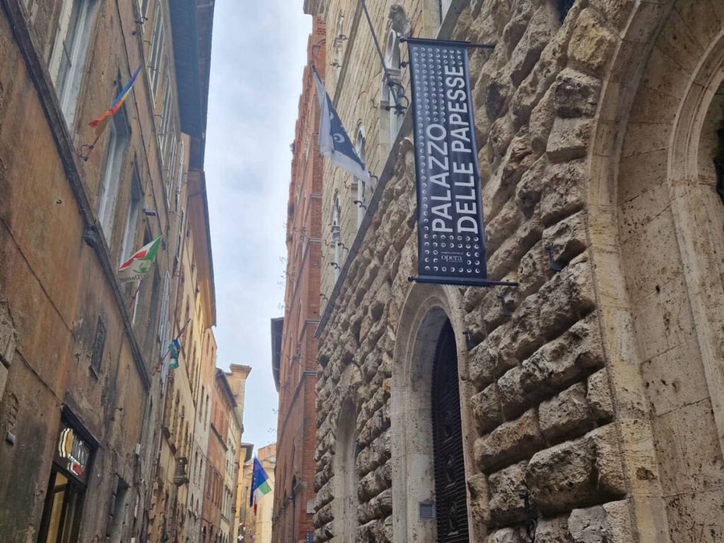 View of the signage of Palazzo delle Papesse against the stone walled exterior