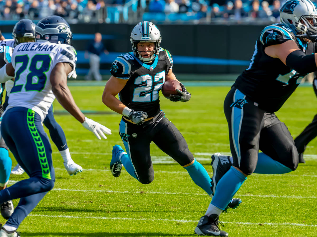 Christian MCCAFFREY (22) runs against the visiting Seattle Seahawks at Bank Of America Stadium