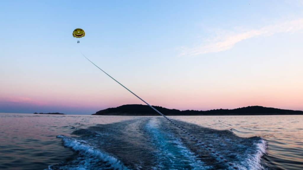 View of the parasailing in Cavtat with a beautiful sunset in the background