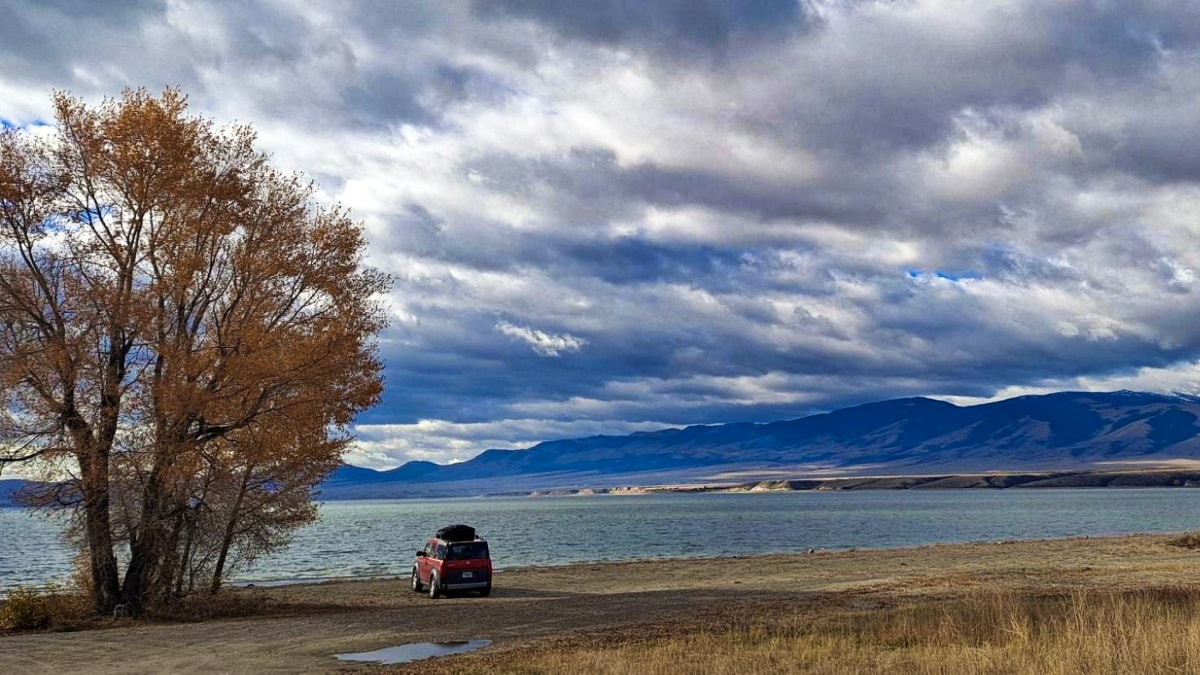 A red car parked near the water in Missouri