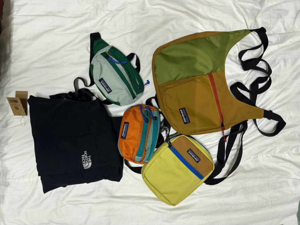 View of the Patagonia bags and North Face hiking pants on the bed