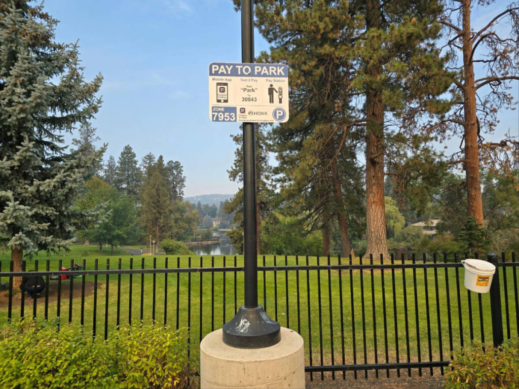A pay to park signage on a park