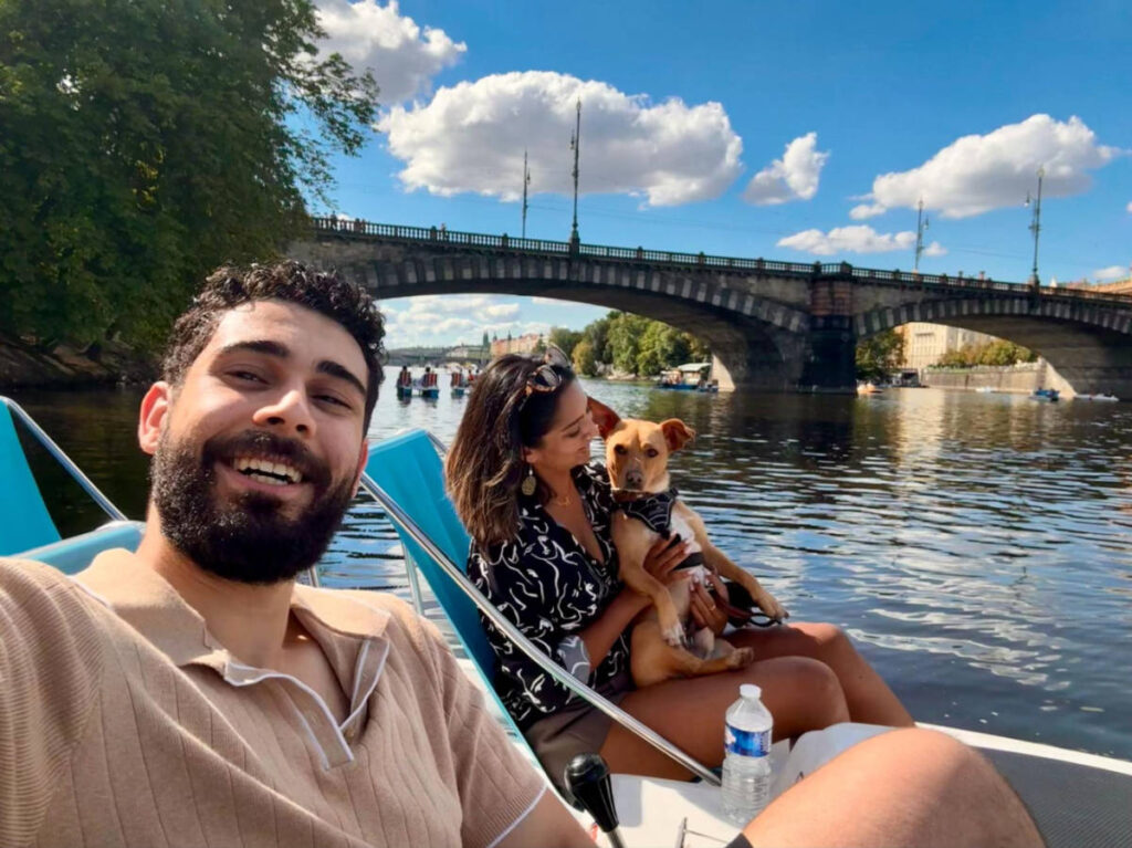 The author Meera Devotta and her partner with their pup pedal boating in Slovanský Ostrov