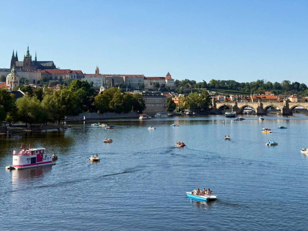 Overlooking view of the people riding the pedal boats in the Vltava