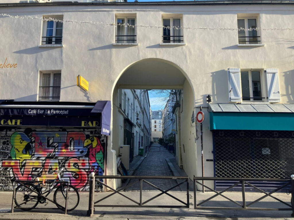 A colorful mural at the entrance to a pedestrian street