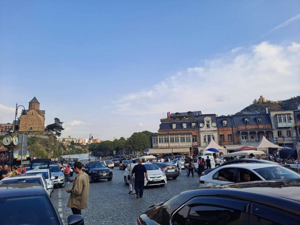 Pedestrians and cars on a road in Georgia