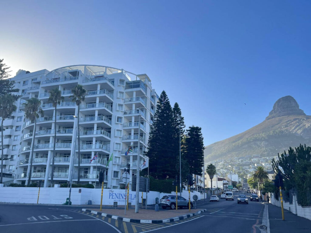 Exterior view of the Peninsula Hotel and the Lion’s Head mountain in the background