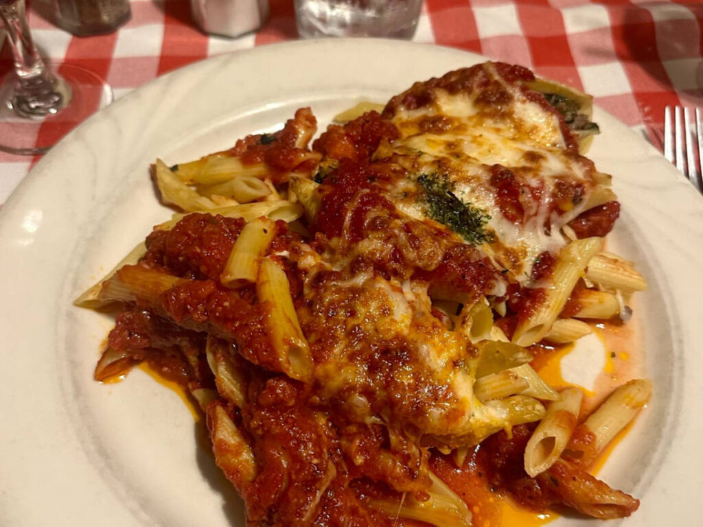A plate with cheese-stuffed shells with penne and meat sauce